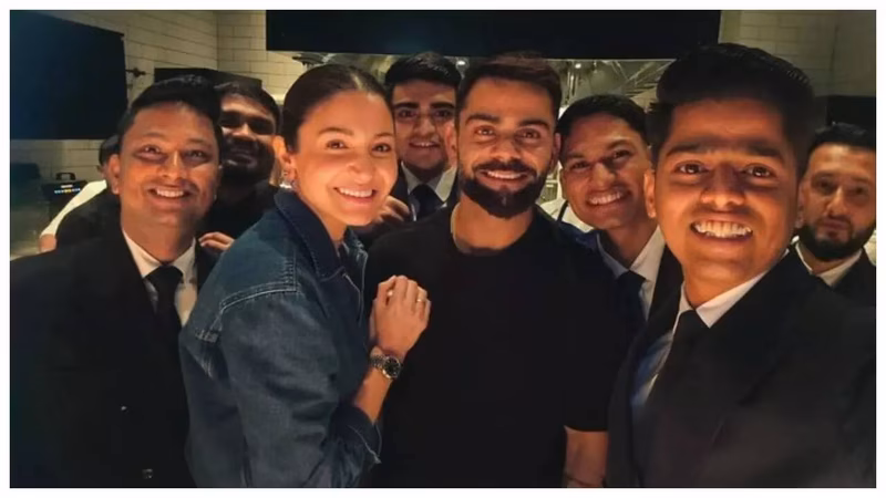 Virat-Anushka are all smiles as they pose with hotel staff- Pics